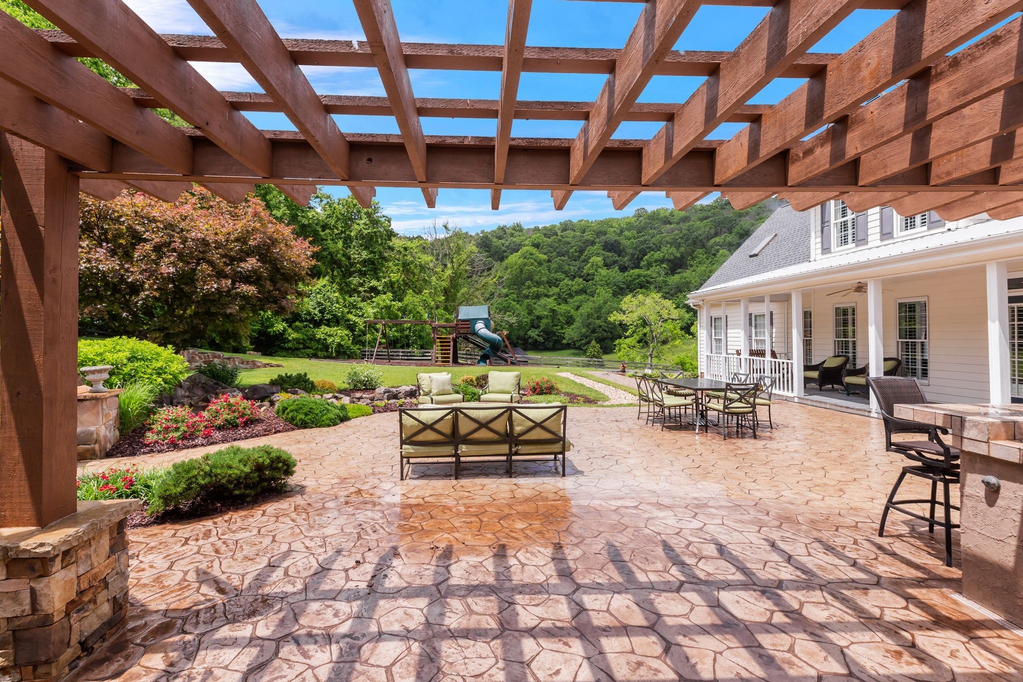 1036 Reed Hollow Road Readyville, TN 37149 - Photo 82 of 90 a view of a patio with a table and chairs under an umbrella