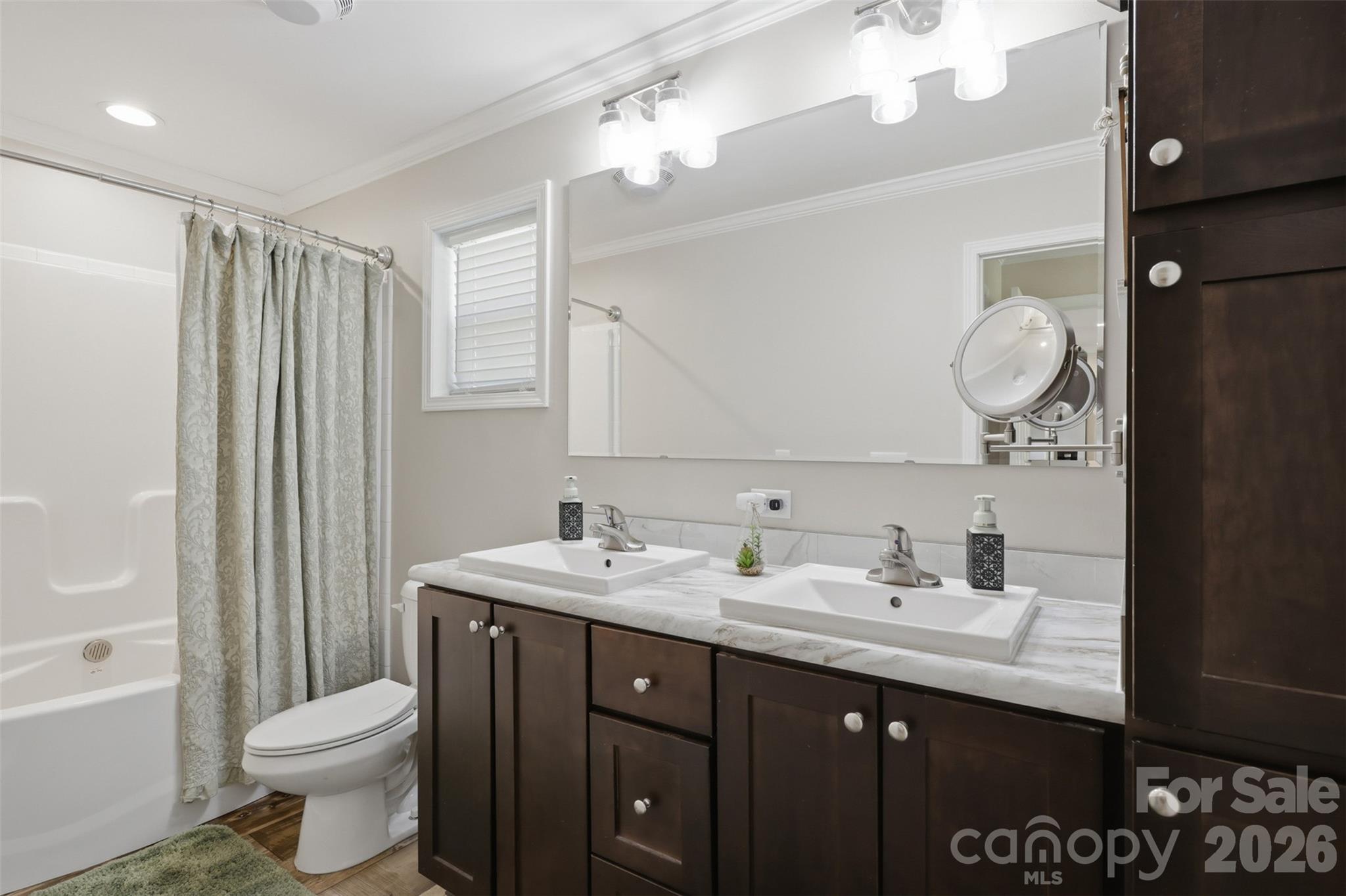 6591 George Hildebran School Road Hickory, NC 28602 - Photo 22 of 41 a bathroom with a double vanity sink toilet and a mirror