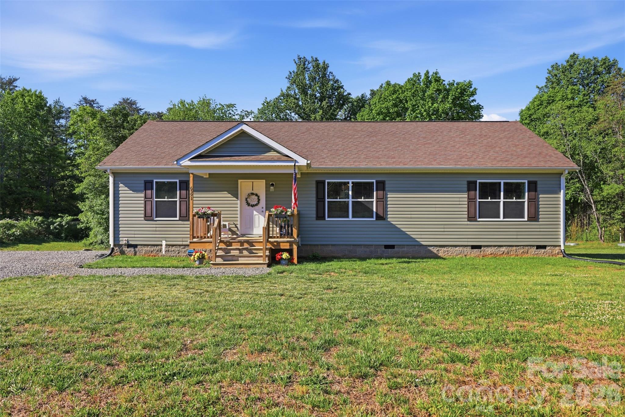6591 George Hildebran School Road Hickory, NC 28602 - Photo 4 of 41 a front view of a house with a garden and trees