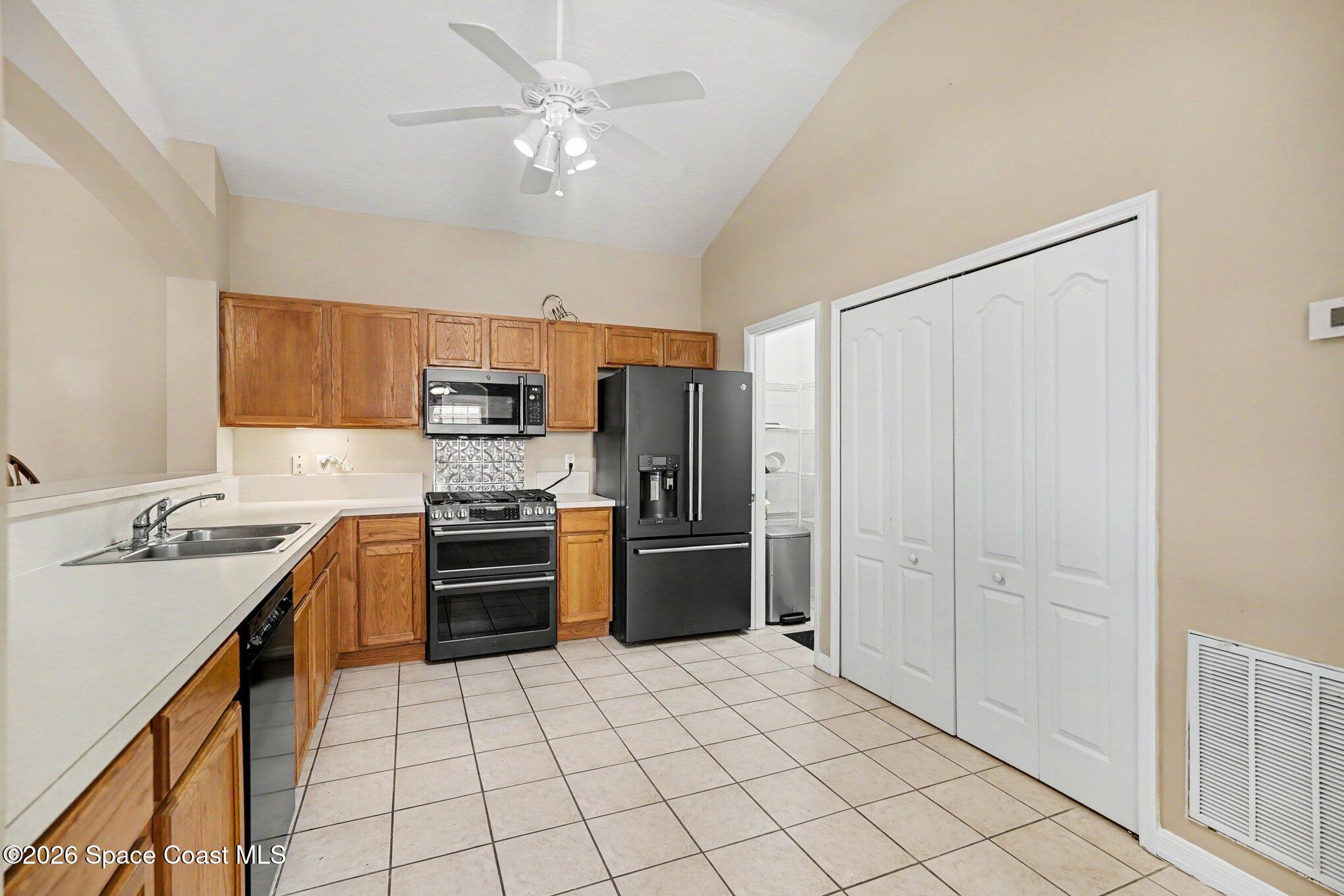 284 Intrepid Way Indialantic, FL 32903 - Photo 17 of 36 a kitchen with stainless steel appliances granite countertop a stove sink and refrigerator