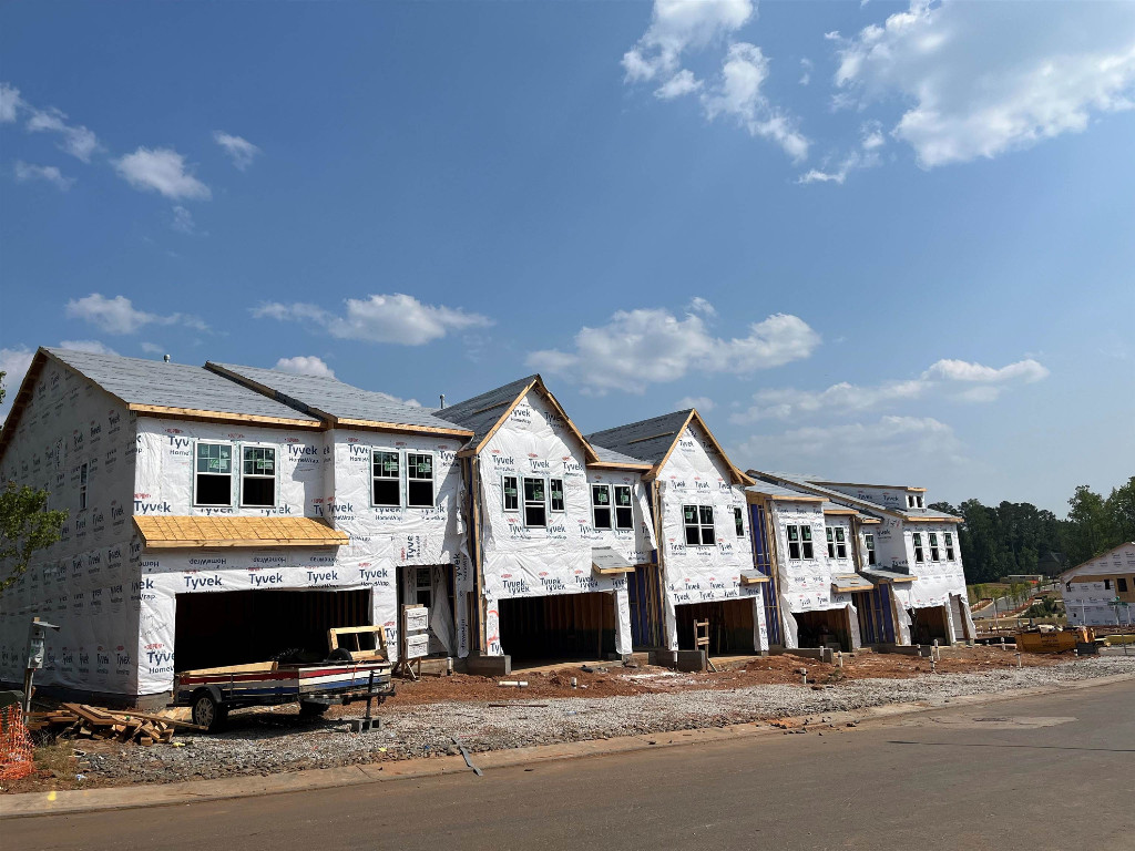 Undisclosed Address Raleigh, NC 27617 - Photo 18 of 37 a front view of multiple houses with yard