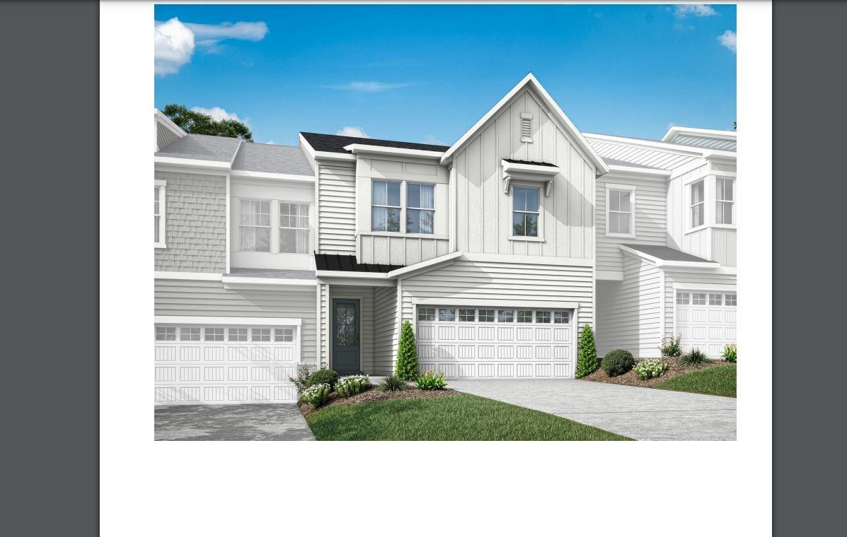 Undisclosed Address Raleigh, NC 27617 - Photo 2 of 37 a front view of a house with a yard and garage