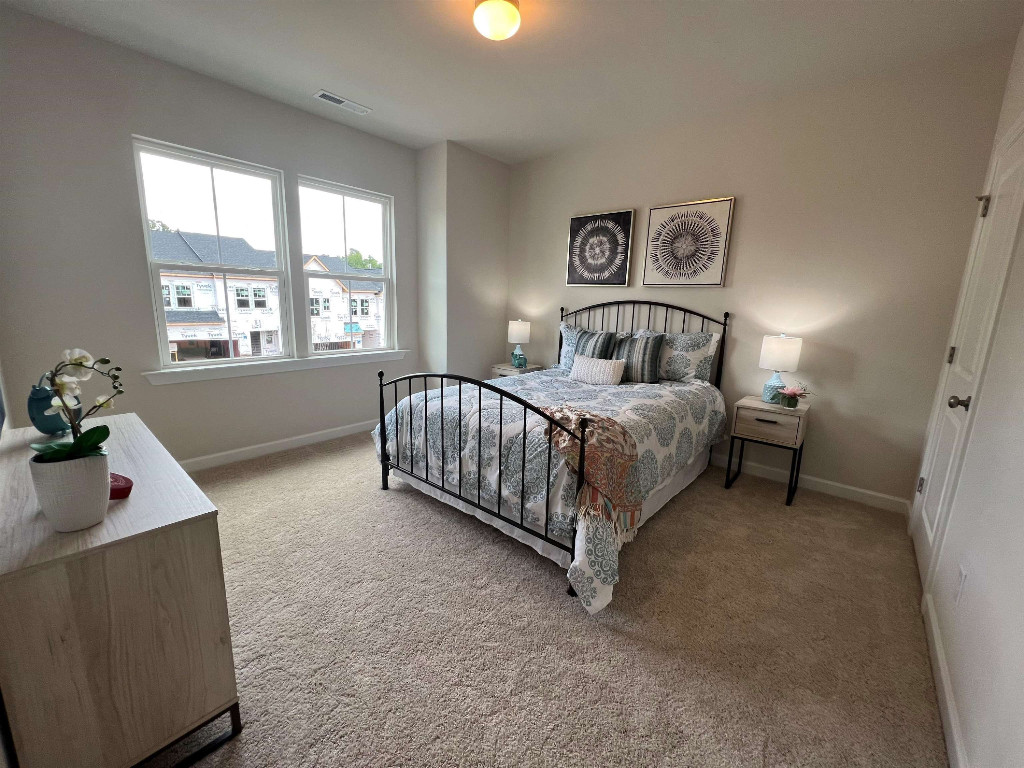 Undisclosed Address Raleigh, NC 27617 - Photo 22 of 37 a bedroom with a bed and a window