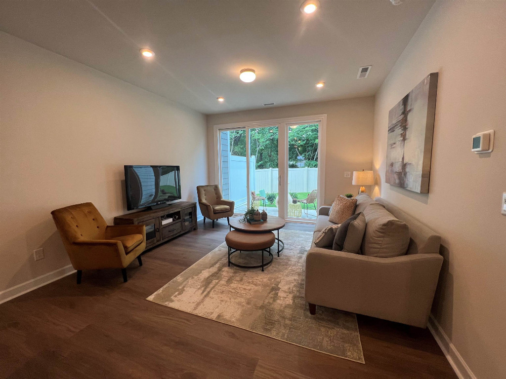 Undisclosed Address Raleigh, NC 27617 - Photo 26 of 37 a living room with furniture and a potted plant
