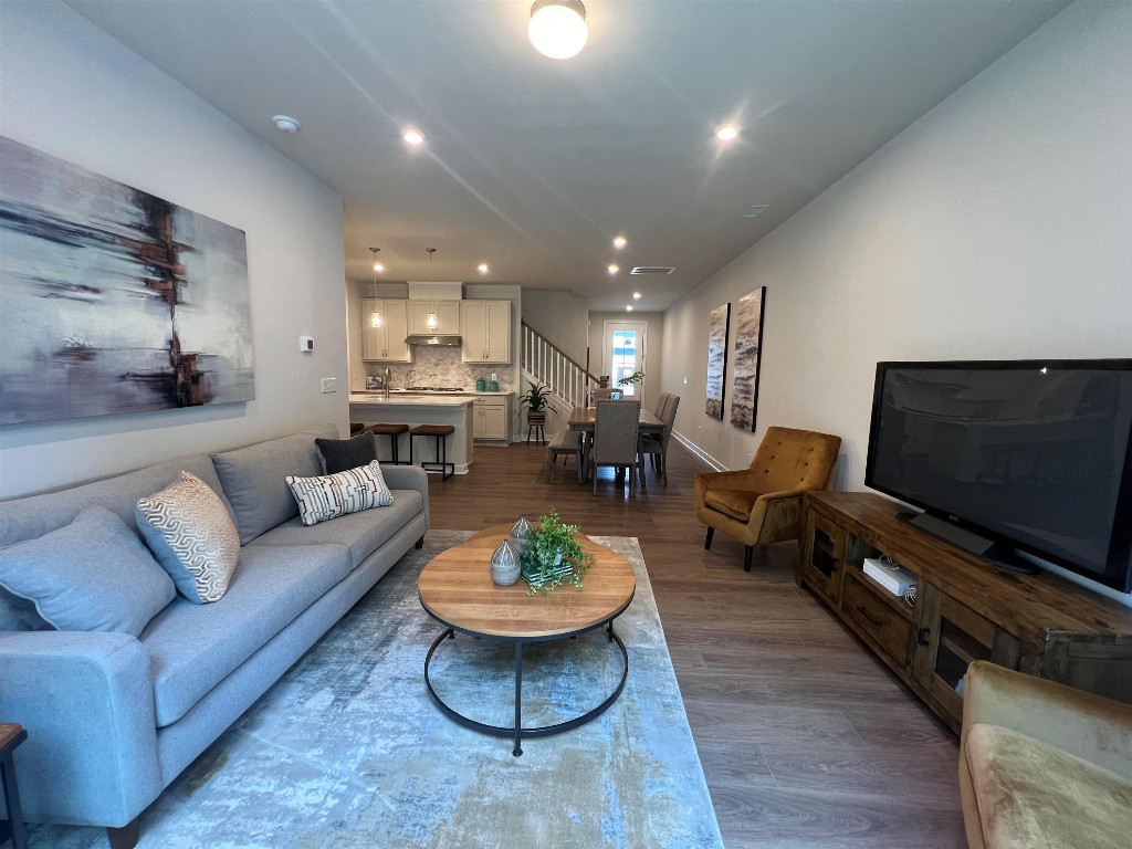 Undisclosed Address Raleigh, NC 27617 - Photo 28 of 37 a living room with furniture and a flat screen tv