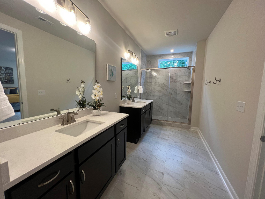Undisclosed Address Raleigh, NC 27617 - Photo 35 of 37 a bathroom with a sink double vanity granite tub shower and a mirror