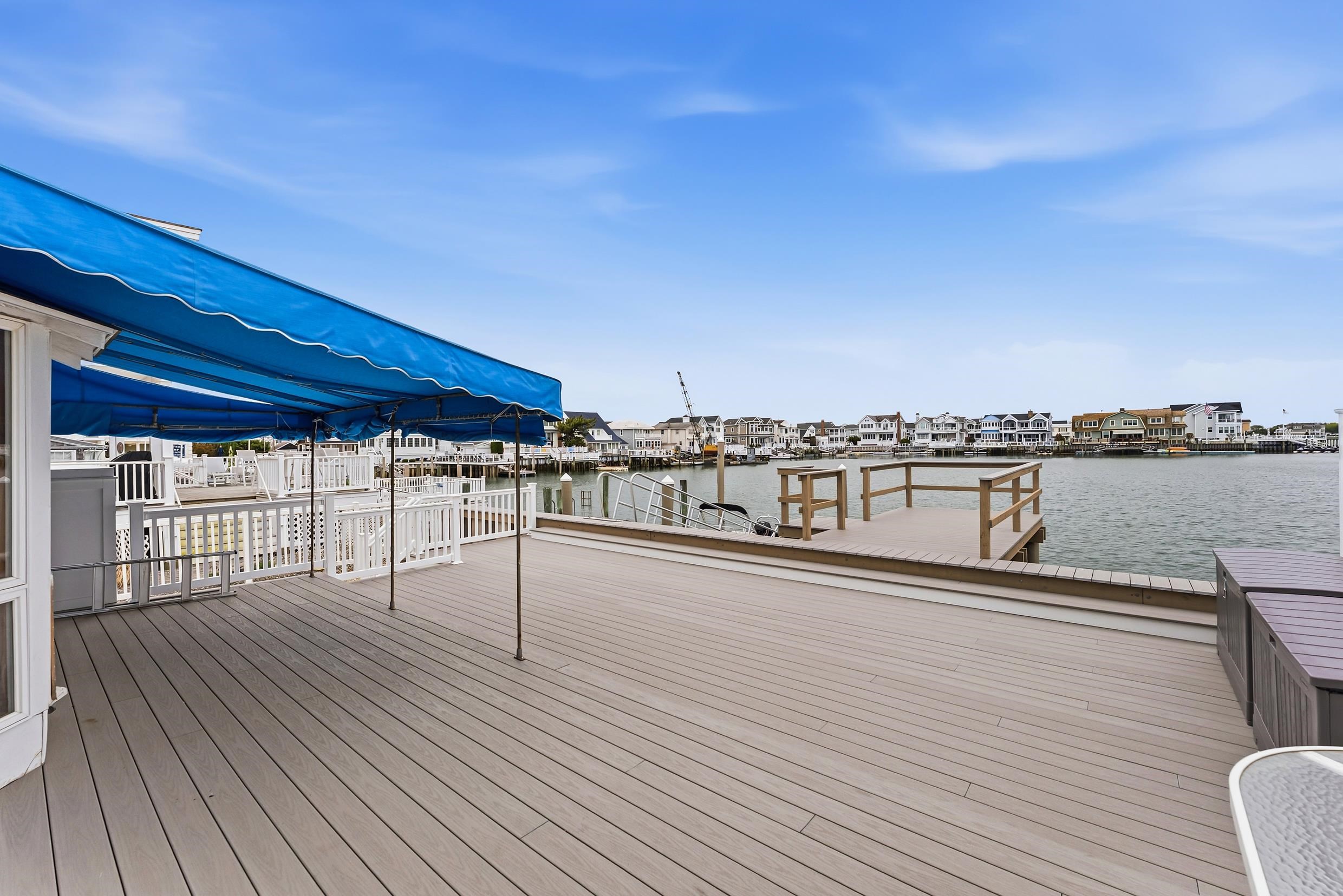 9727 3rd, Unit A1 Stone Harbor, NJ 08247 - Photo 10 of 20 a view of a balcony with wooden floor and seating