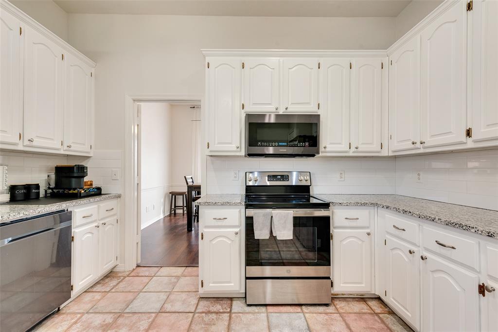 106 Villanova Circle Forney, TX 75126 - Photo 11 of 26 a kitchen with cabinets stainless steel appliances and a counter space