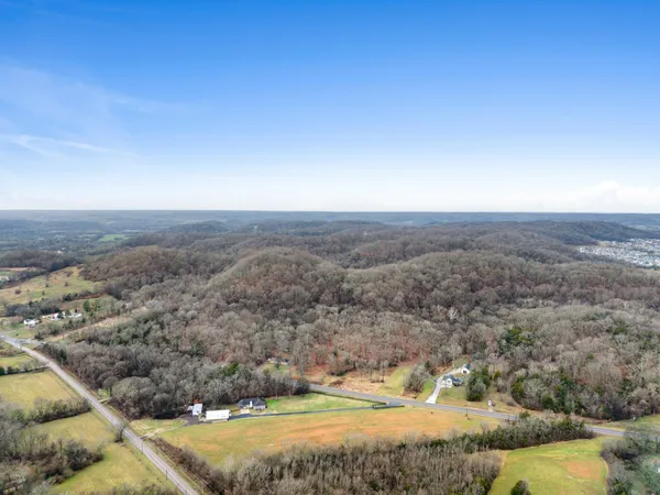 an aerial view of a house with a mountain