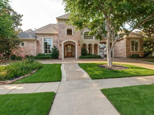 a front view of a house with yard and green space