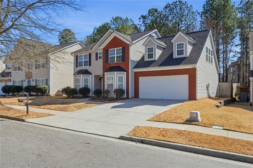 3570 Bogan Mill Road Northeast Buford, GA 30519 - Photo 2 of 31 a front view of a house with a garage