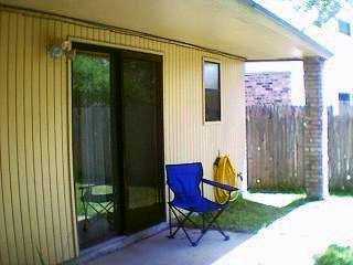 4422 Holly Ridge Drive Corpus Christi, TX 78413 - Photo 3 of 4 a view of a backyard with table and chairs and wooden fence