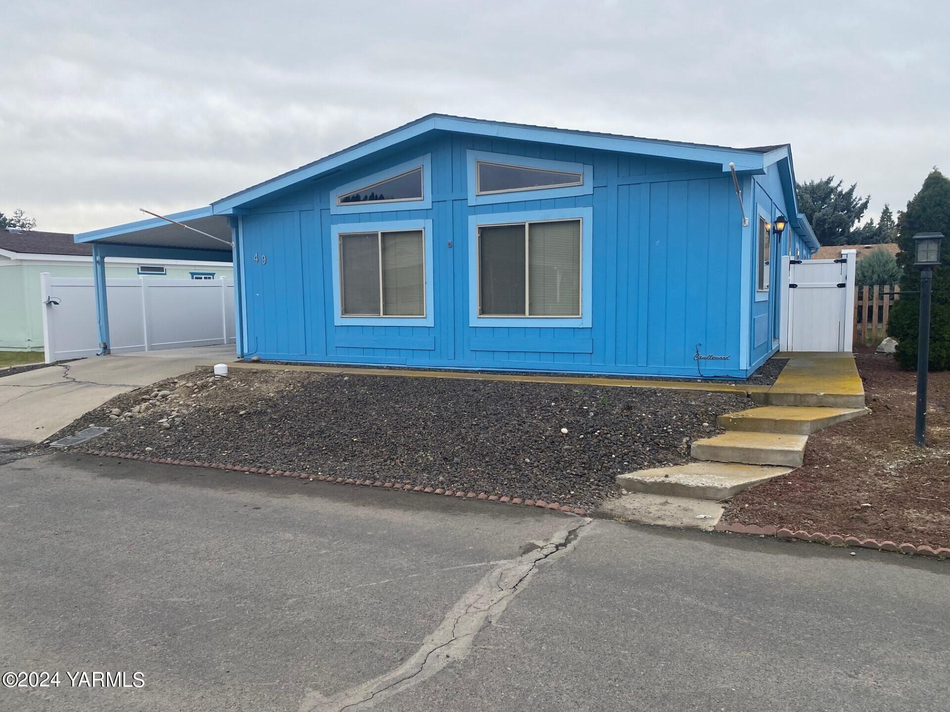 3701 Gun Club Road, Unit 49 Yakima, WA 98901 - Photo 1 of 14 a front view of a house with a yard