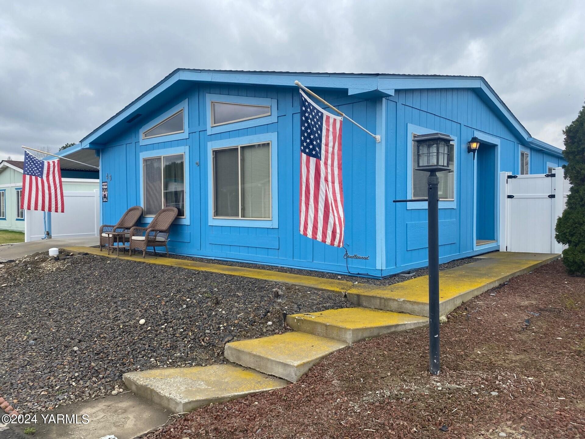 3701 Gun Club Road, Unit 49 Yakima, WA 98901 - Photo 2 of 14 a view of a house with a backyard