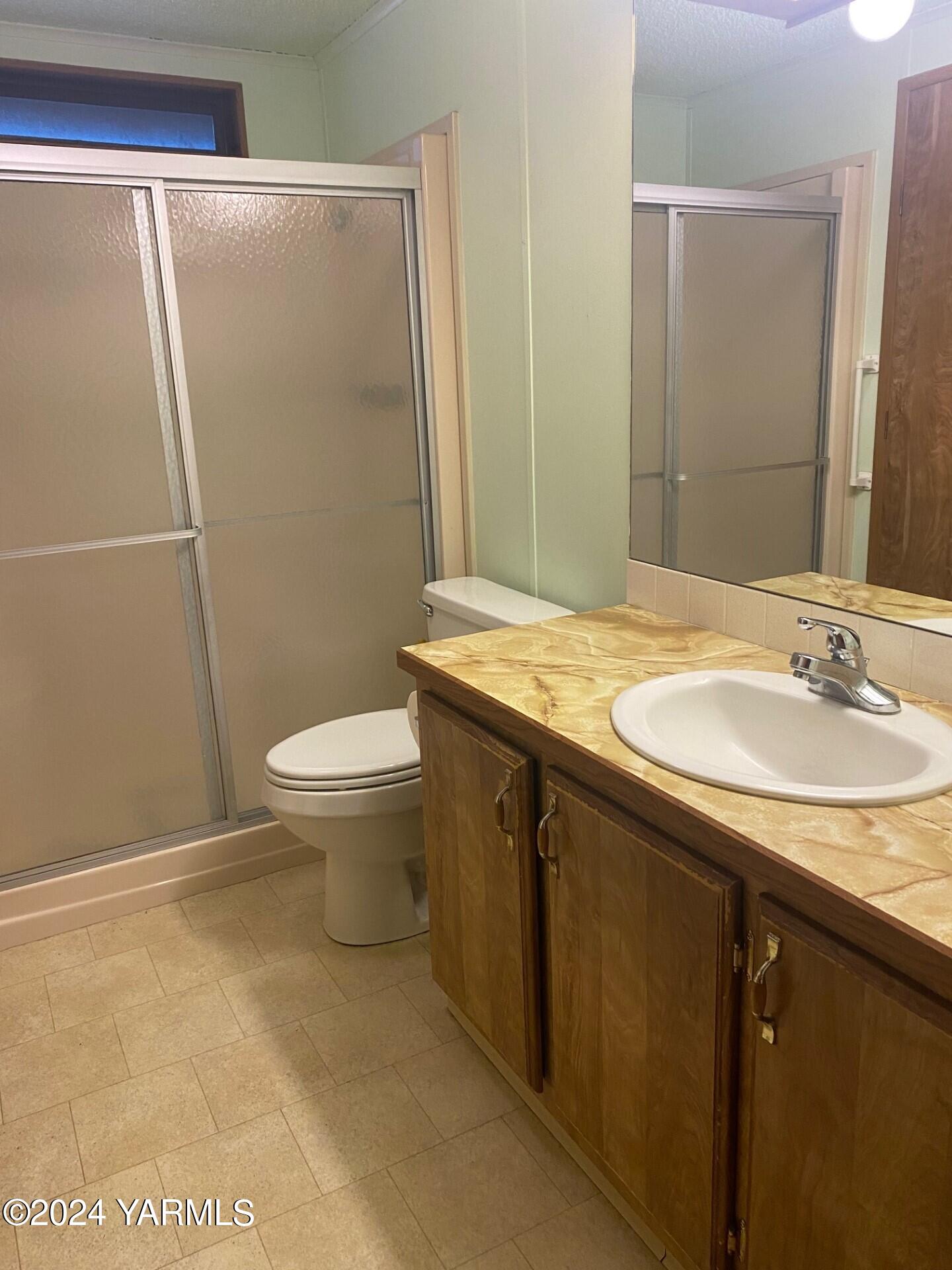 3701 Gun Club Road, Unit 49 Yakima, WA 98901 - Photo 9 of 14 a bathroom with a granite countertop sink toilet and shower