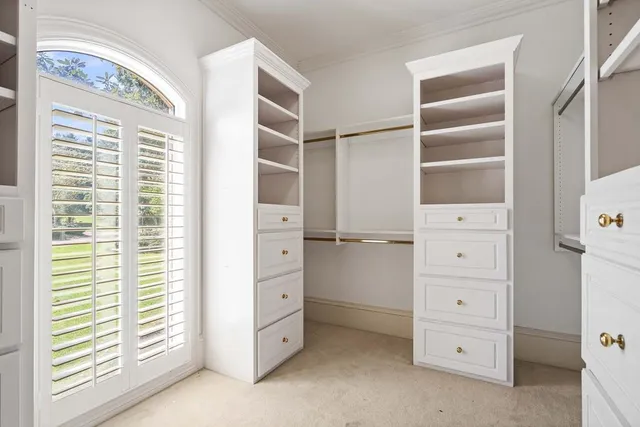 a view of an empty room with a fireplace and a window