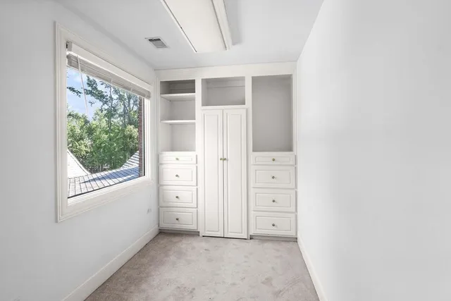 a front view of a house with a garden and sitting area