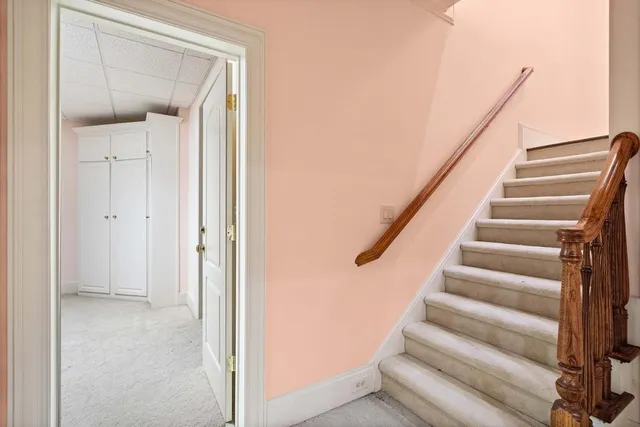 a front view of a house with a yard and potted plants