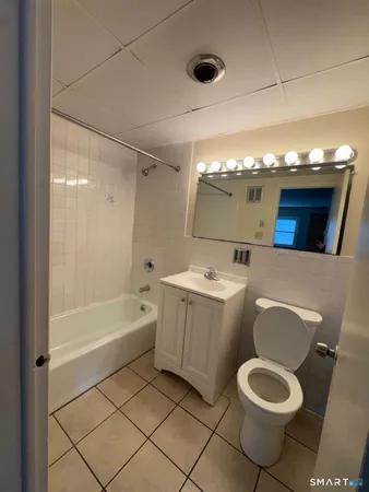 a bathroom with a sink a toilet and bathtub