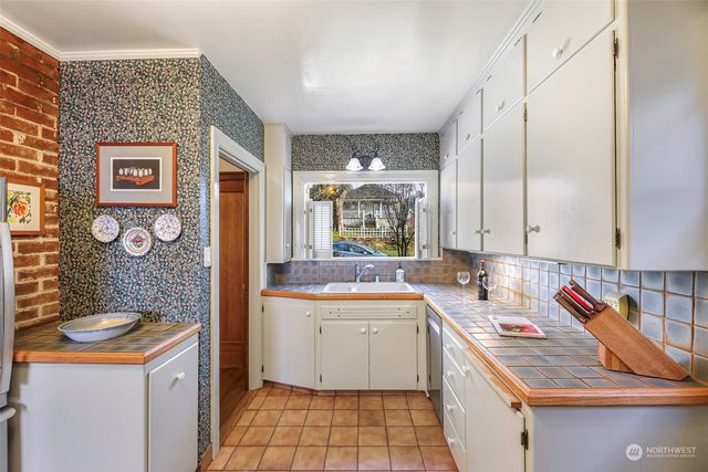 a kitchen with a sink stove and cabinets