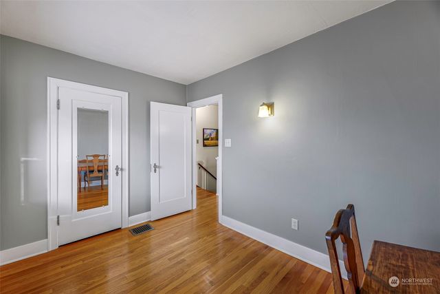 a view of empty room with wooden floor