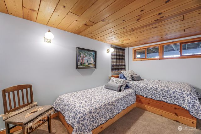 a bedroom with bed and wooden floor