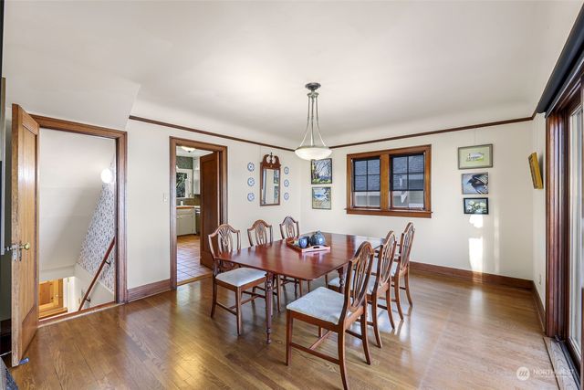 a view of a dining room with furniture window and wooden floor