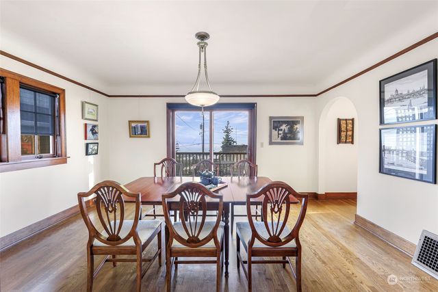 a view of a dining room with furniture window and wooden floor