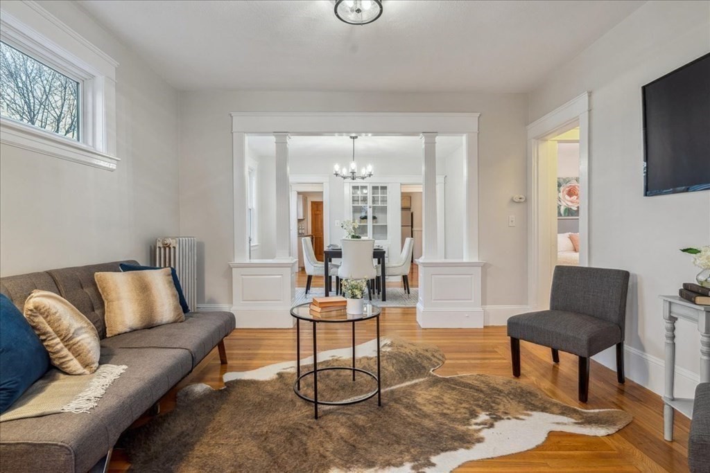 a living room with furniture and a chandelier