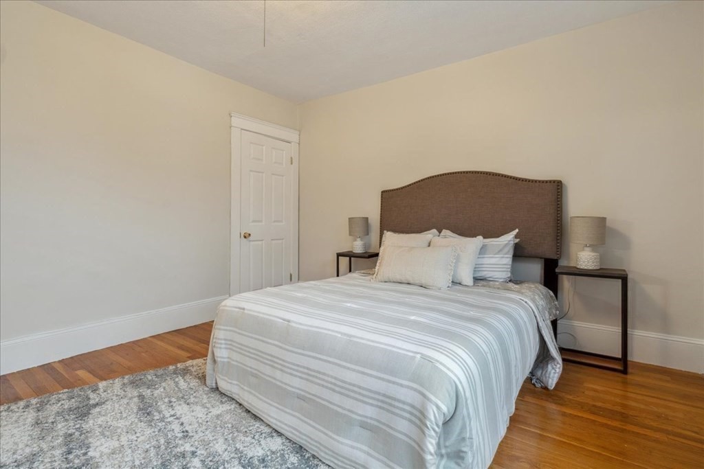 41 Blanchard Road, Unit 41 Cambridge, MA 02138 - Photo 15 of 36 a bedroom with a bed and wooden floor