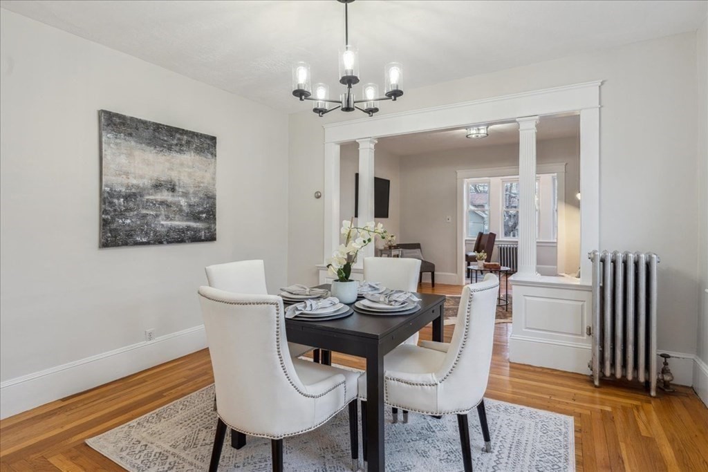 41 Blanchard Road, Unit 41 Cambridge, MA 02138 - Photo 6 of 36 a dining room with furniture a chandelier and wooden floor