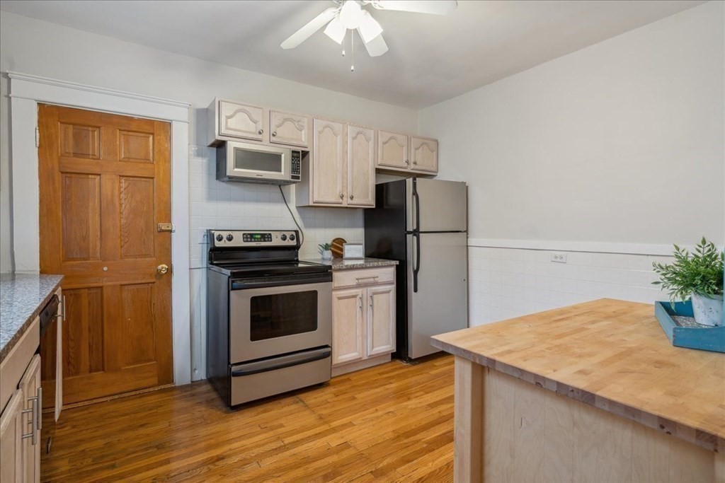 41 Blanchard Road, Unit 41 Cambridge, MA 02138 - Photo 9 of 36 a kitchen with a appliances and a refrigerator