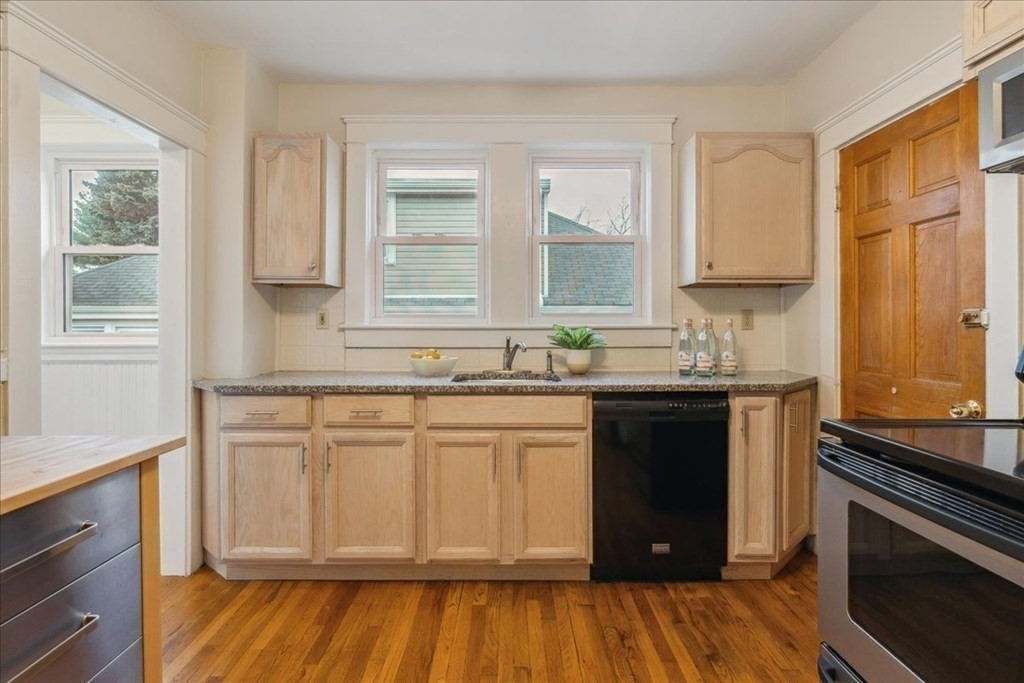 41 Blanchard Road, Unit 41 Cambridge, MA 02138 - Photo 10 of 36 a kitchen with granite countertop white cabinets and wooden floor