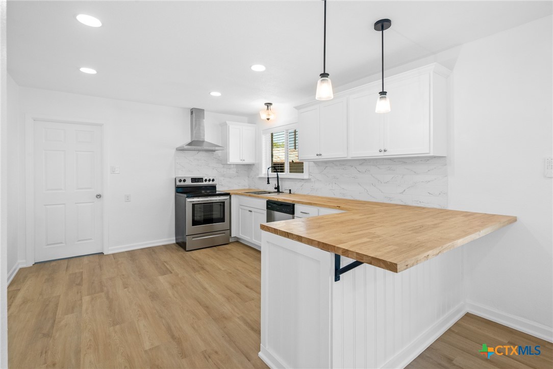 208 Eleanor Street Victoria, TX 77904 - Photo 16 of 40 a kitchen with stainless steel appliances granite countertop a sink a stove and a refrigerator