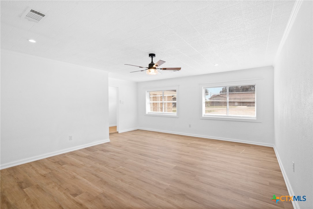208 Eleanor Street Victoria, TX 77904 - Photo 22 of 40 a view of an empty room with wooden floor and a window
