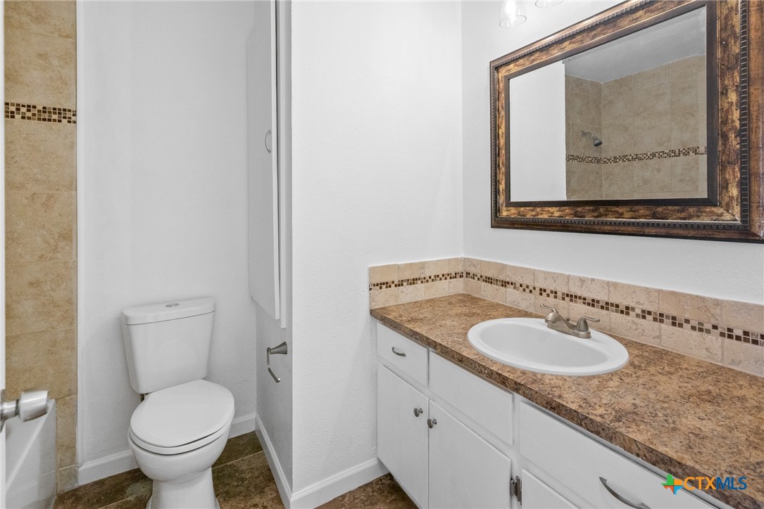 208 Eleanor Street Victoria, TX 77904 - Photo 24 of 40 a bathroom with a toilet sink and mirror