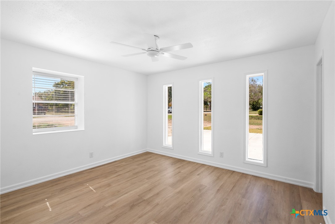 208 Eleanor Street Victoria, TX 77904 - Photo 27 of 40 a view of an empty room with a window and wooden floor