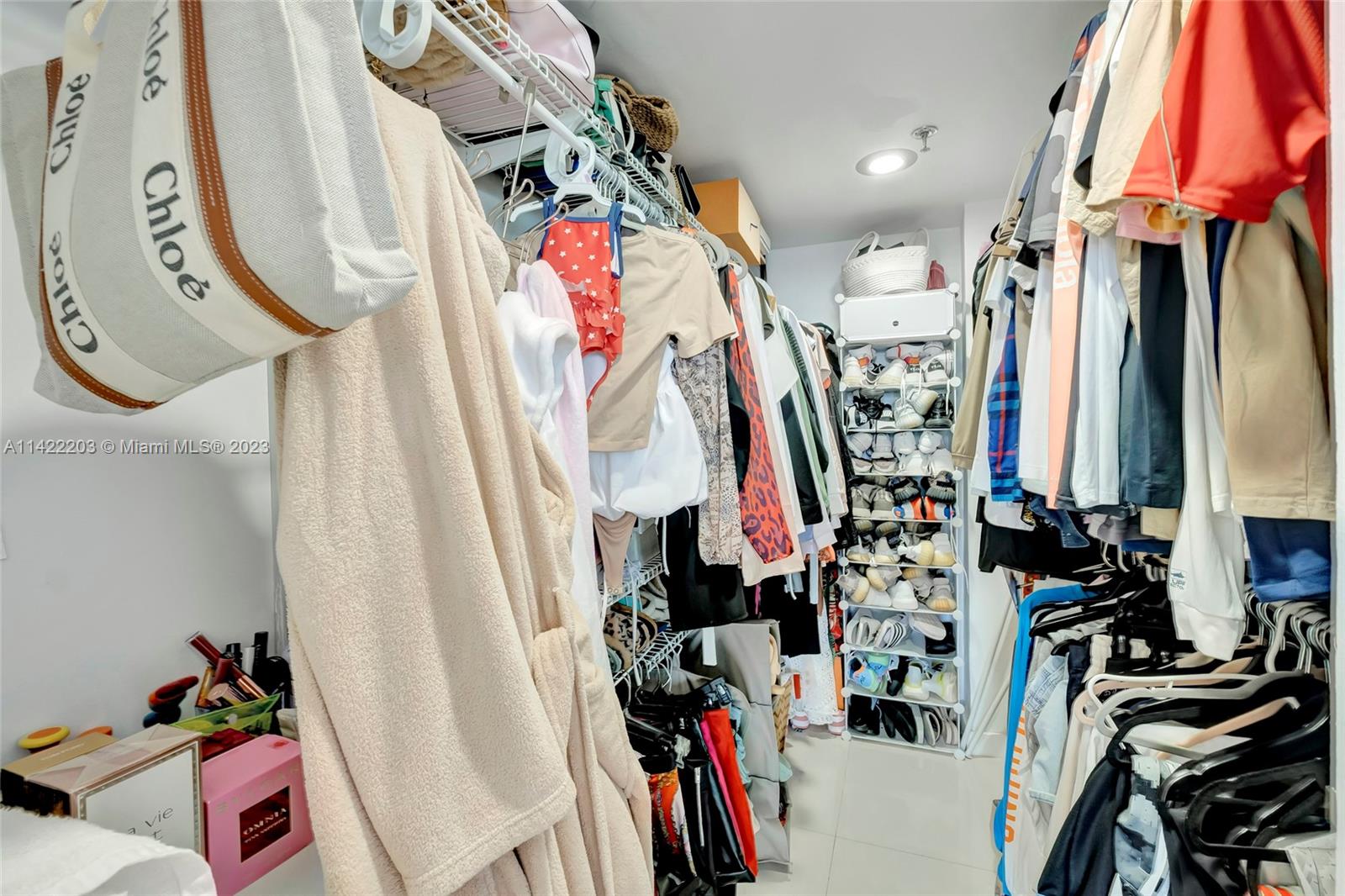 555 Northeast 15th Street, Unit 20B Miami, FL 33132 - Photo 14 of 33 a view of walk in closet with clothes and shoes