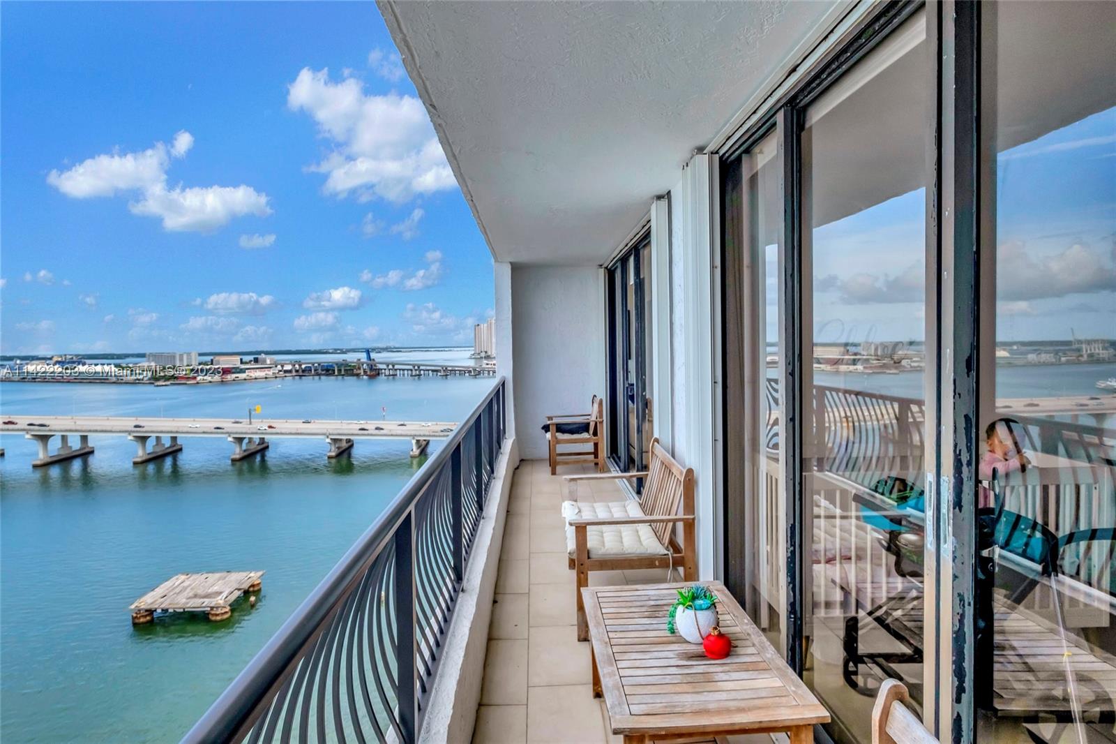 555 Northeast 15th Street, Unit 20B Miami, FL 33132 - Photo 18 of 33 a balcony with wooden floor and outdoor seating