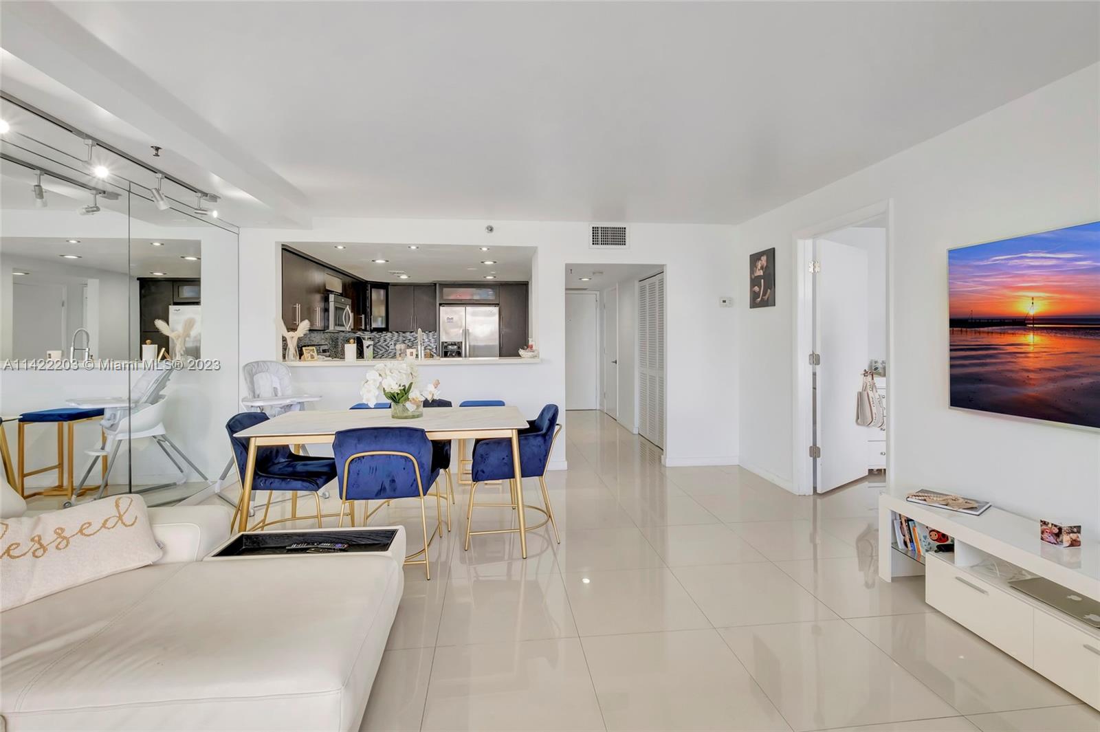 555 Northeast 15th Street, Unit 20B Miami, FL 33132 - Photo 2 of 33 a living room with furniture a flat screen tv and kitchen view
