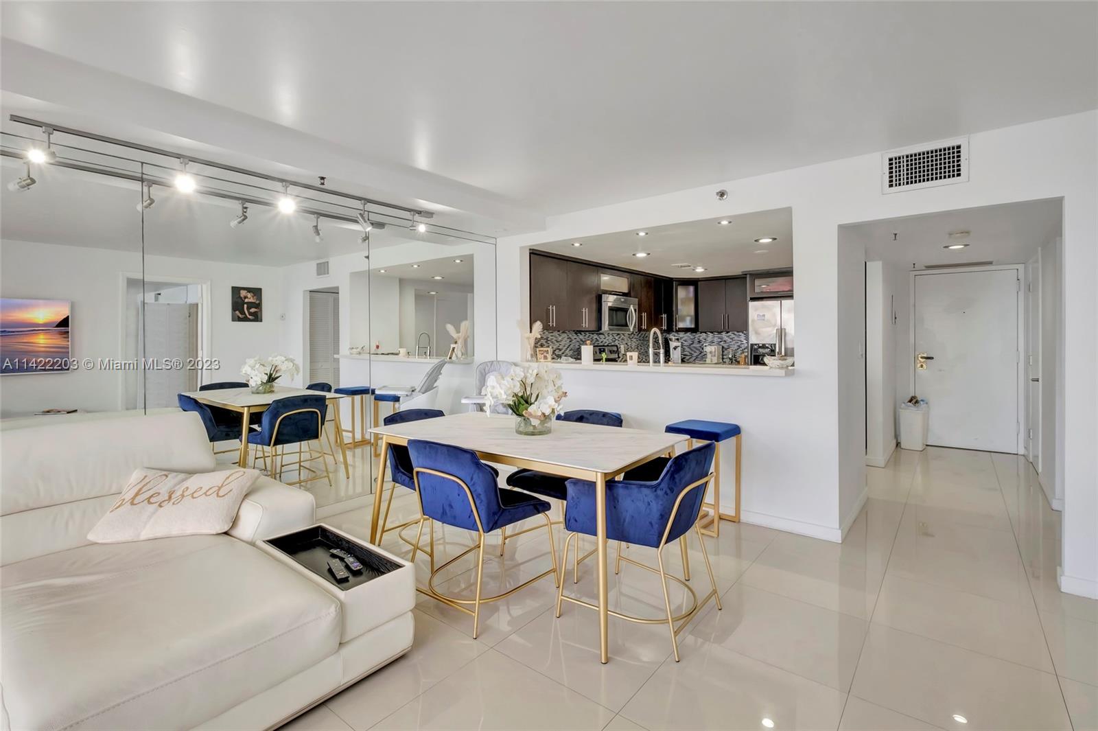 555 Northeast 15th Street, Unit 20B Miami, FL 33132 - Photo 3 of 33 a living room with furniture a table and chairs