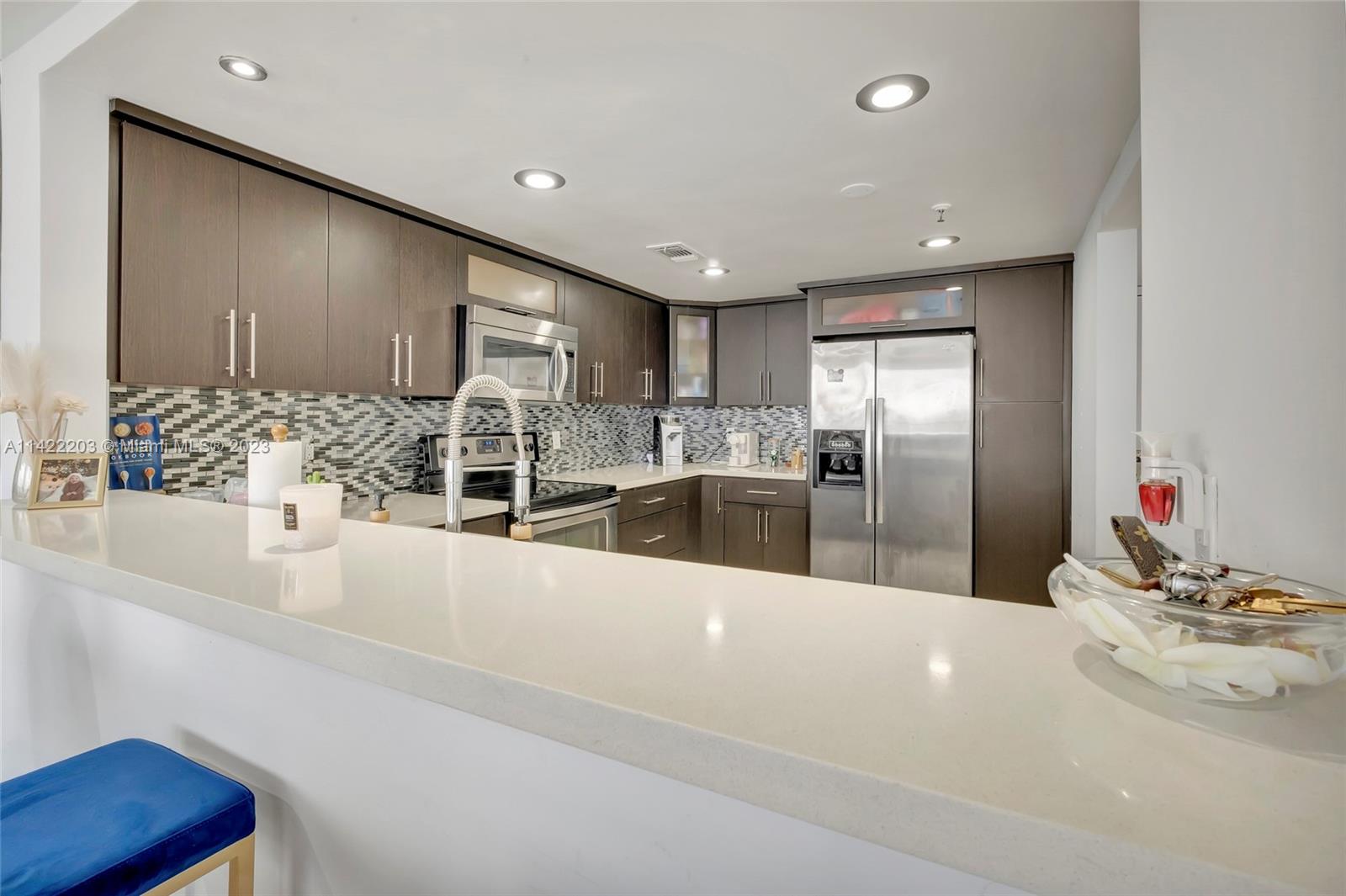 555 Northeast 15th Street, Unit 20B Miami, FL 33132 - Photo 4 of 33 a large kitchen with kitchen island a sink stainless steel appliances and cabinets