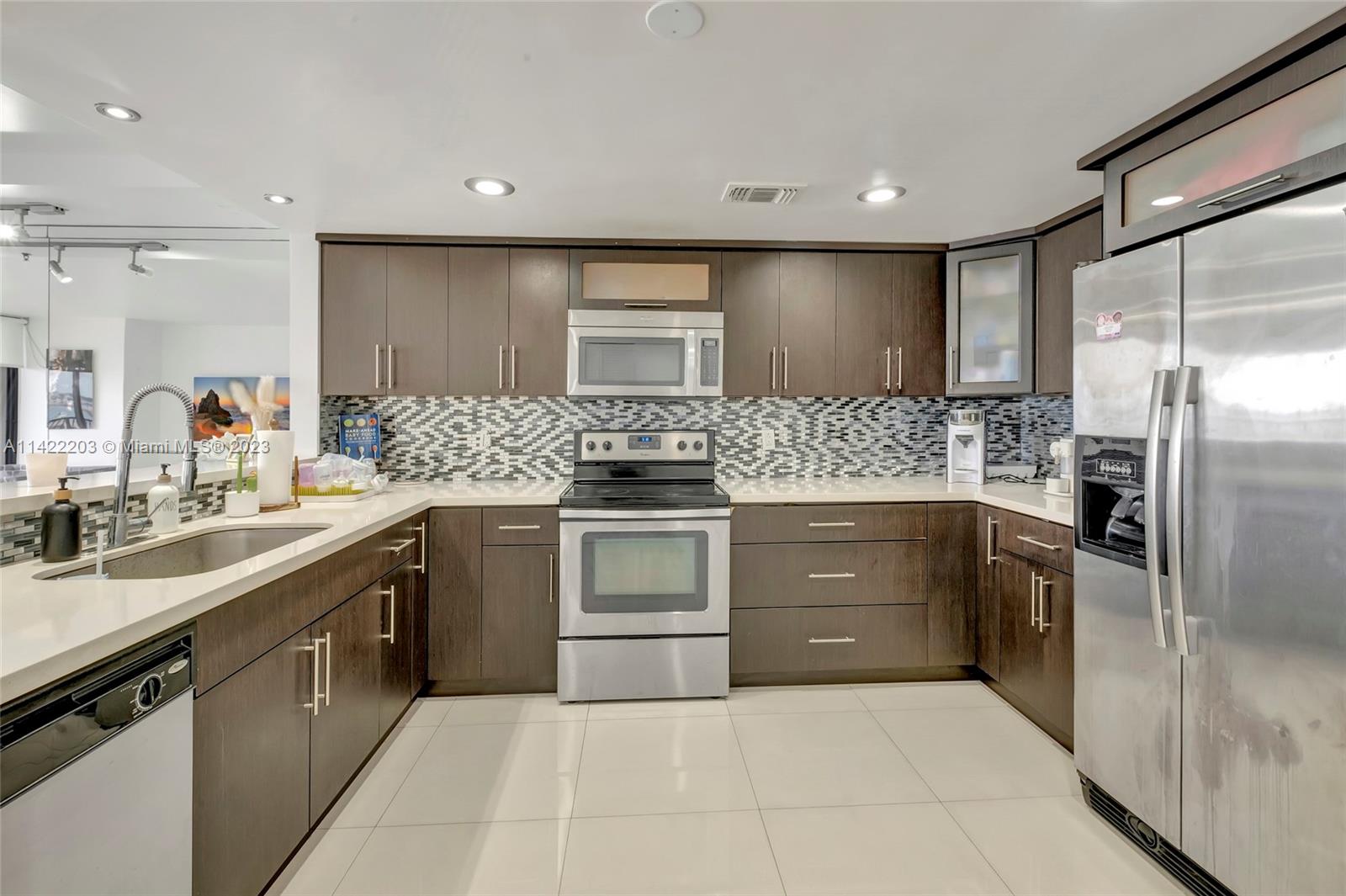 555 Northeast 15th Street, Unit 20B Miami, FL 33132 - Photo 5 of 33 a kitchen with a sink stove and refrigerator