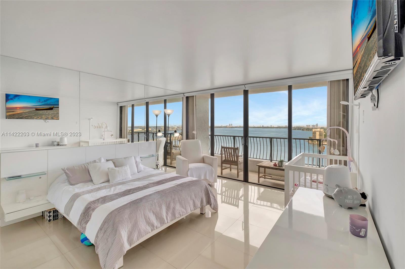 555 Northeast 15th Street, Unit 20B Miami, FL 33132 - Photo 10 of 33 a spacious bedroom with a large bed and a large window