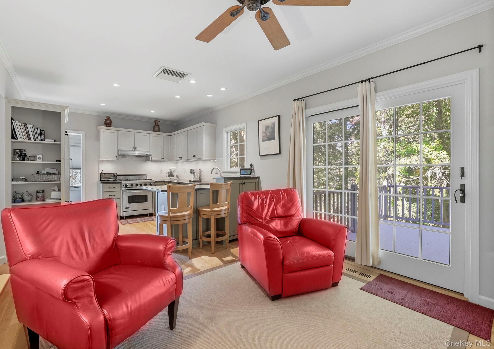 122 Harriman Road Mount Kisco, NY 10549 - Photo 13 of 39 a living room with furniture a ceiling fan and a large window