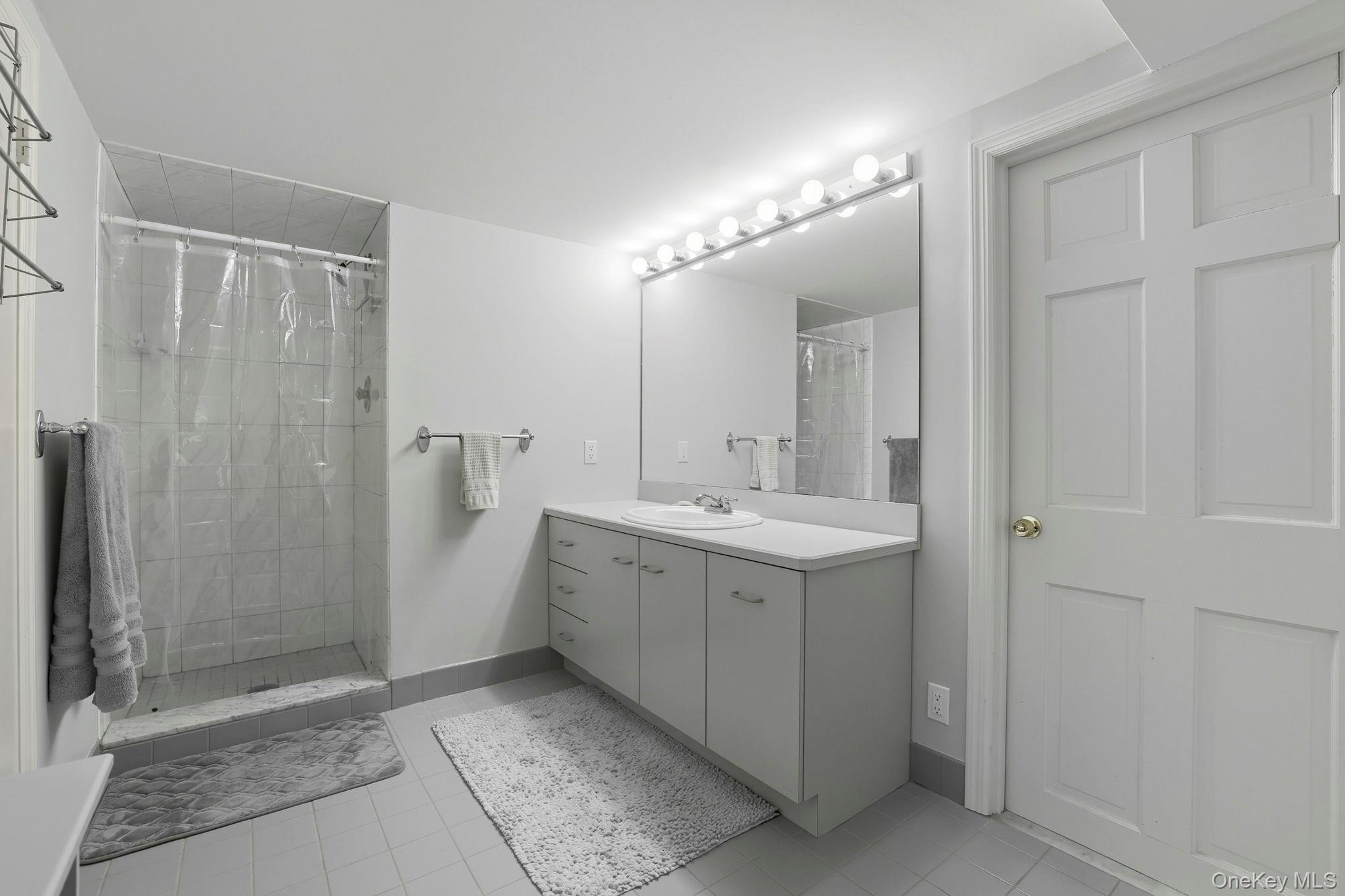 122 Harriman Road Mount Kisco, NY 10549 - Photo 26 of 39 a bathroom with a double vanity sink and mirror