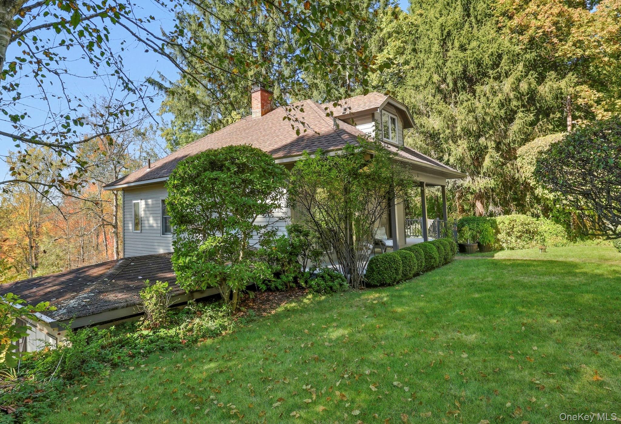122 Harriman Road Mount Kisco, NY 10549 - Photo 31 of 39 a view of a house with a yard and plants