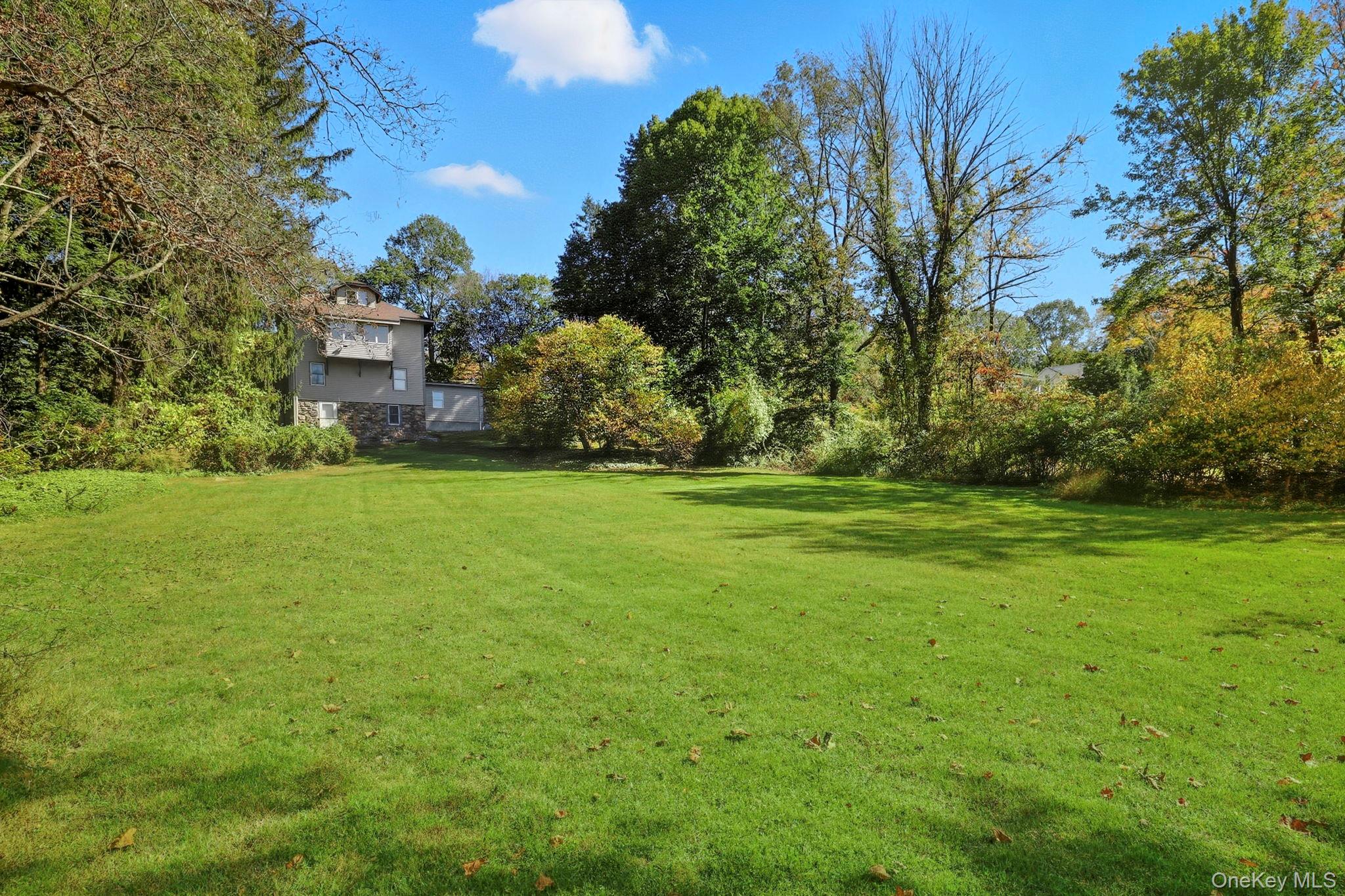 122 Harriman Road Mount Kisco, NY 10549 - Photo 34 of 39 a backyard of a house with lots of green space