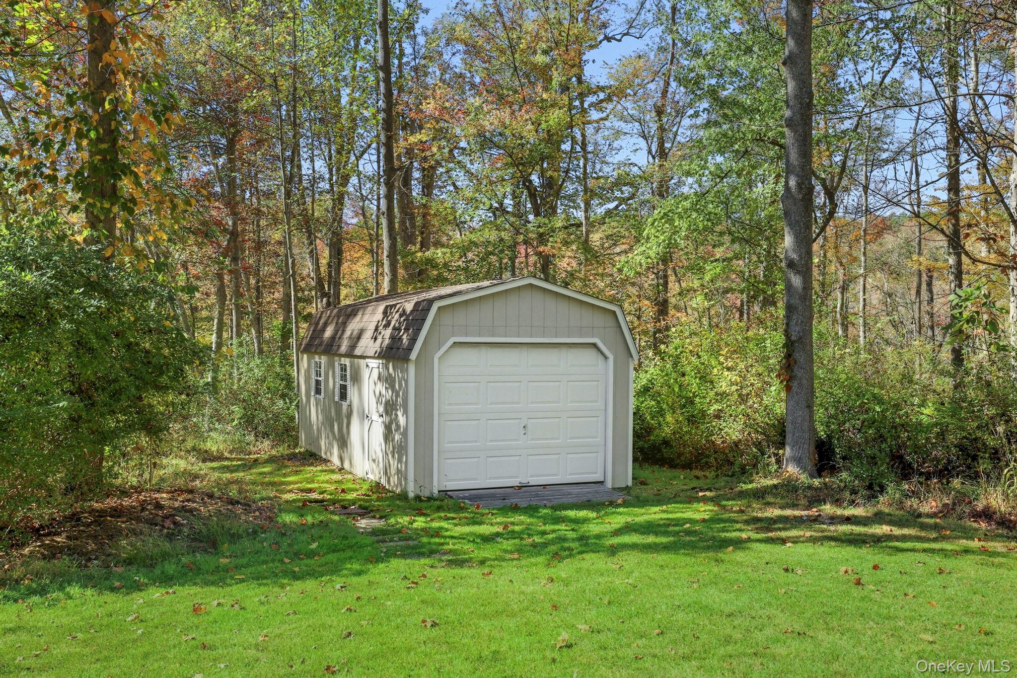 122 Harriman Road Mount Kisco, NY 10549 - Photo 35 of 39 a backyard of a house with lots of green space