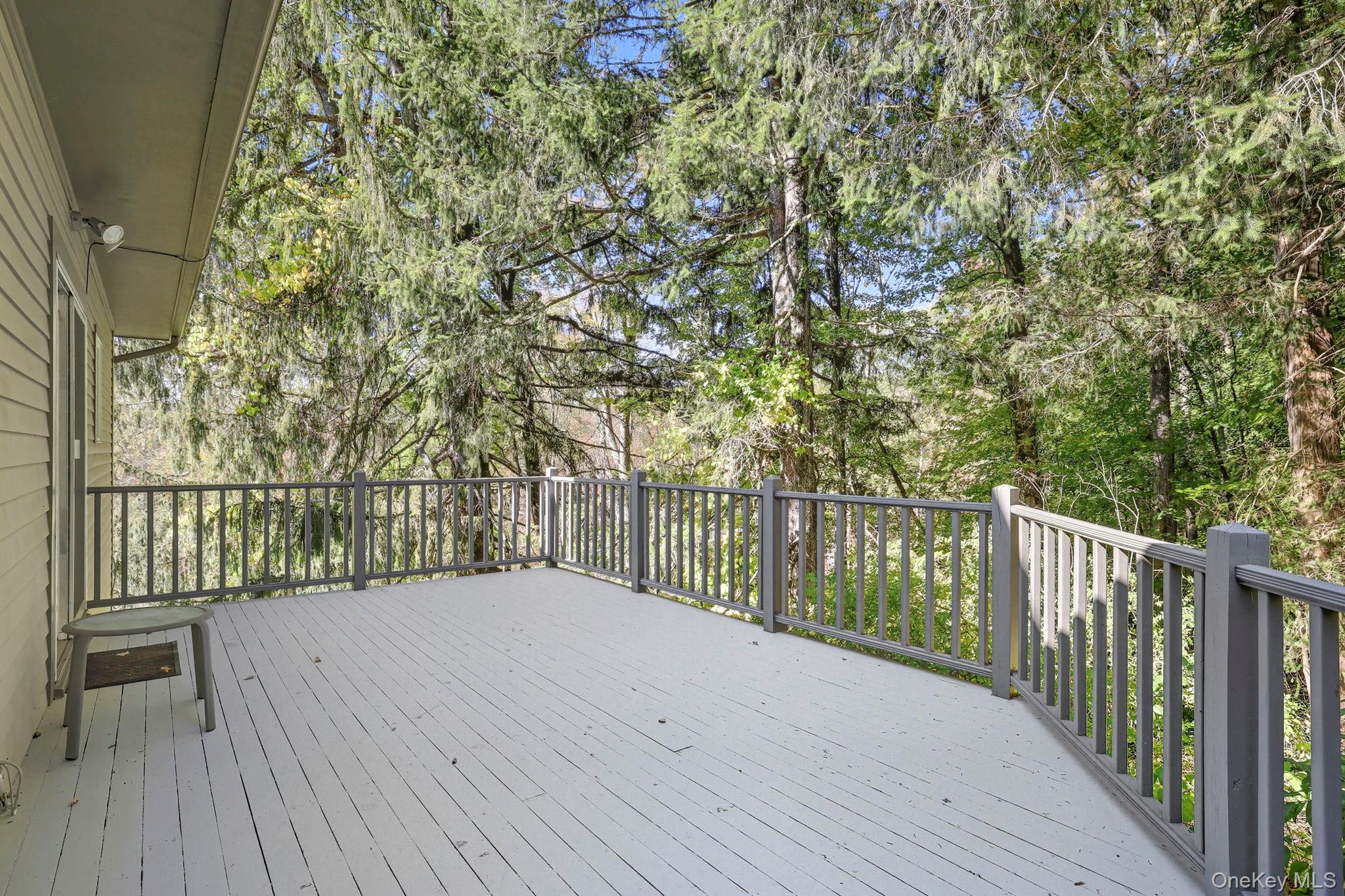 122 Harriman Road Mount Kisco, NY 10549 - Photo 6 of 39 a balcony with trees in front of it